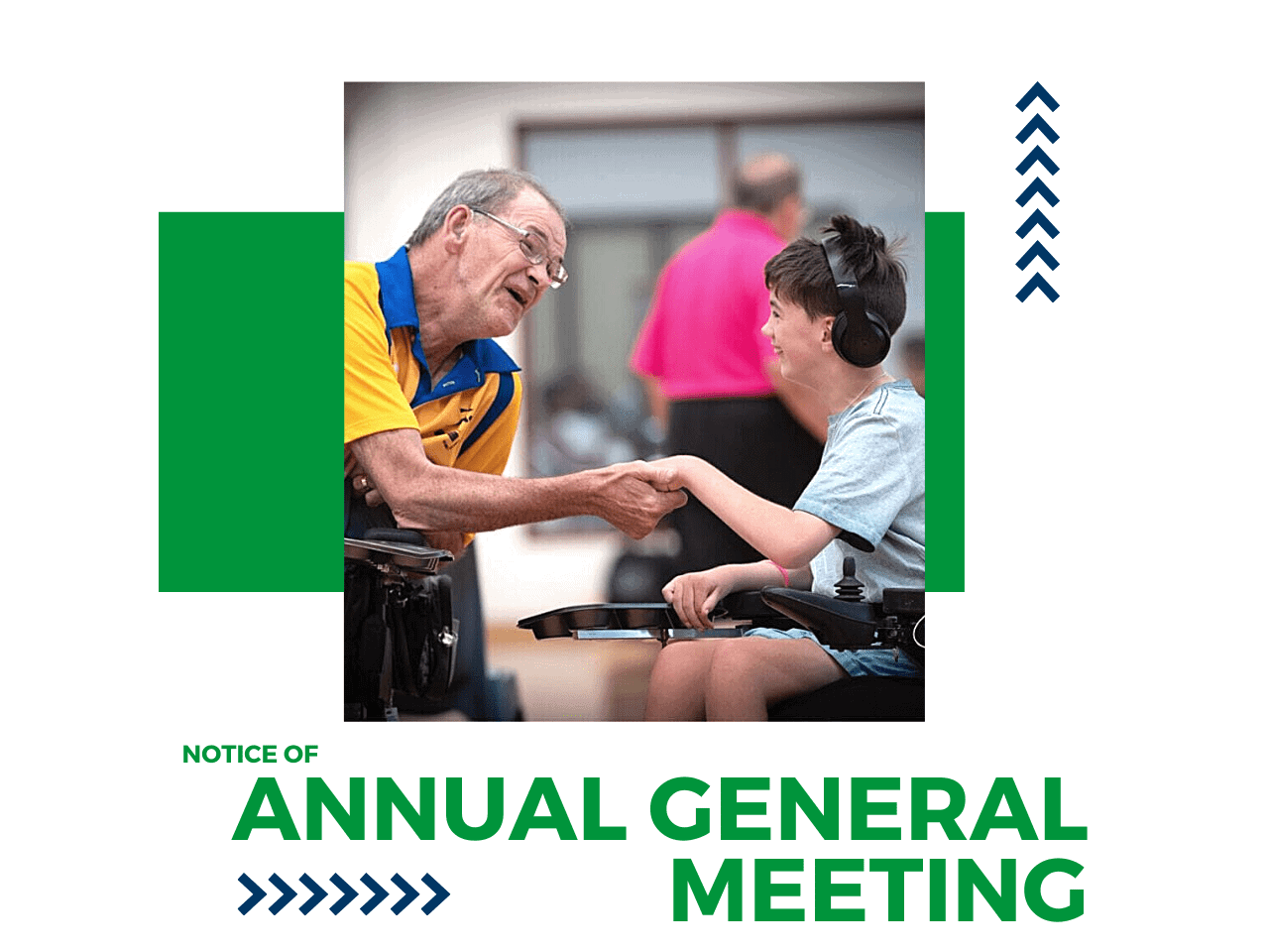 An older wheelchair user and younger wheelchair user come together to shake hands.