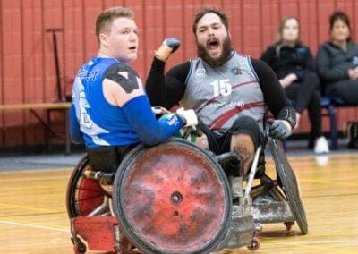 A wheelchair rugby player celebrates their victory after a match.