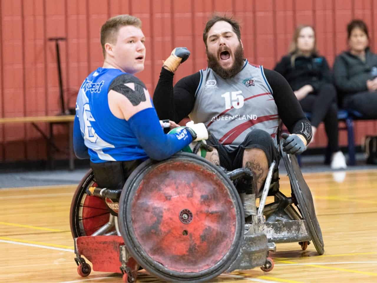 A wheelchair rugby player celebrates their victory after a match.