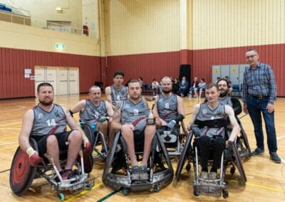 Wheelchair rugby men’s team grouped together for a team photo.
