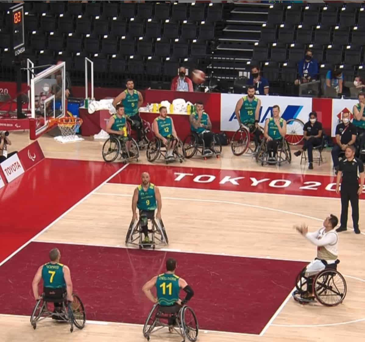 Paralympian shoots the ball in a game of wheelchair basketball at the Paralympics.