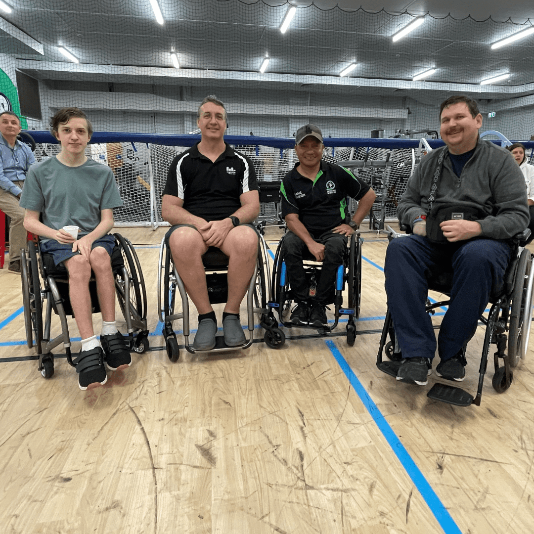 Four male Sporting Wheelies members socialising together.