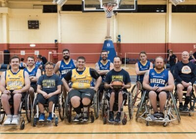 Men's wheelchair basketball team grouped together for a photo.